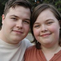 Matthew and Lucia, an engaged couple with Down syndrome, smiling together