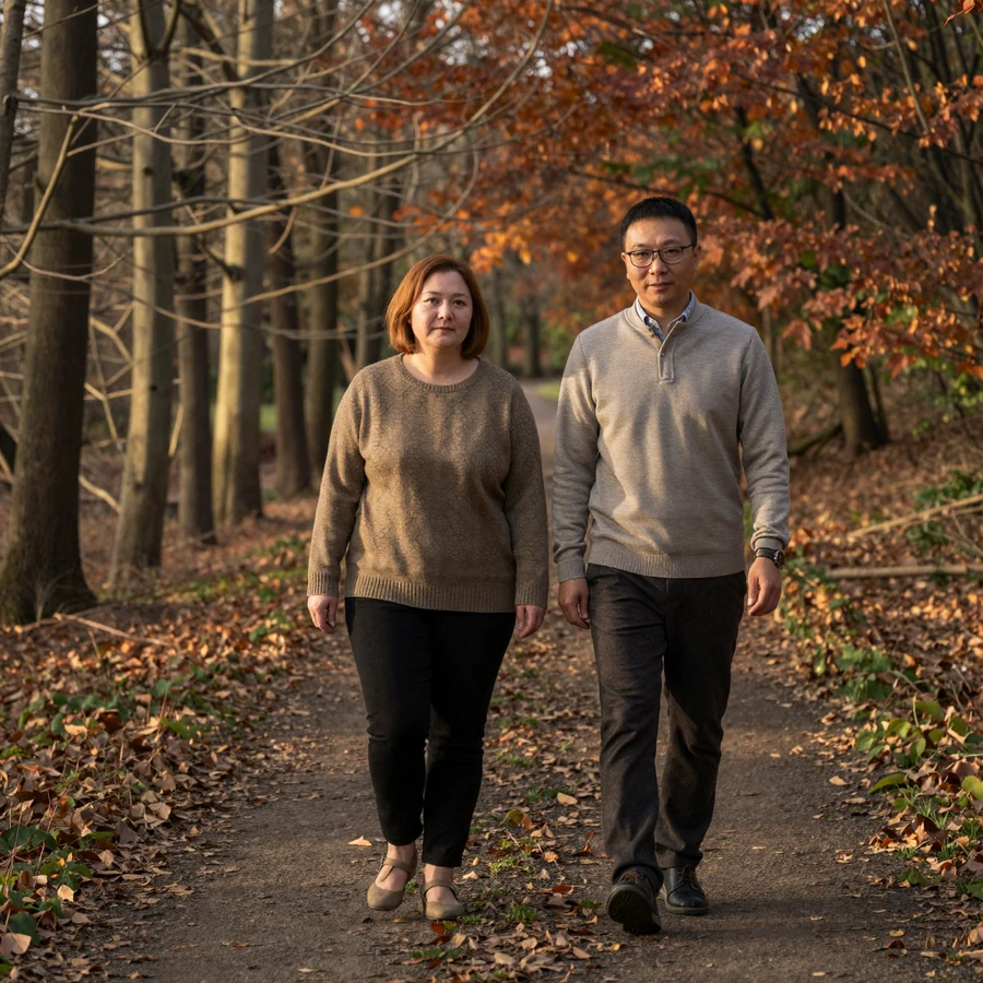 Couple walking quietly on a wooded path in autumn - consistent unhurried connection after trauma