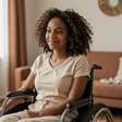 Maya, a Black woman wheelchair user smiling at home