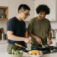 Jordan and Theo, an autistic couple cooking together at home